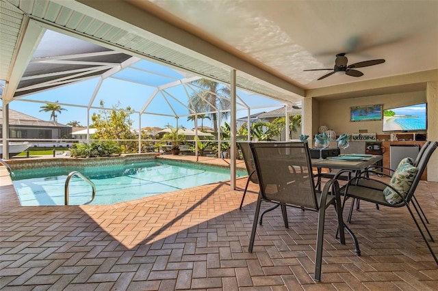 outdoor pool featuring a patio area, glass enclosure, outdoor dining area, and a ceiling fan