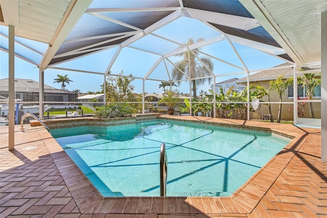 outdoor pool with a patio area and a lanai