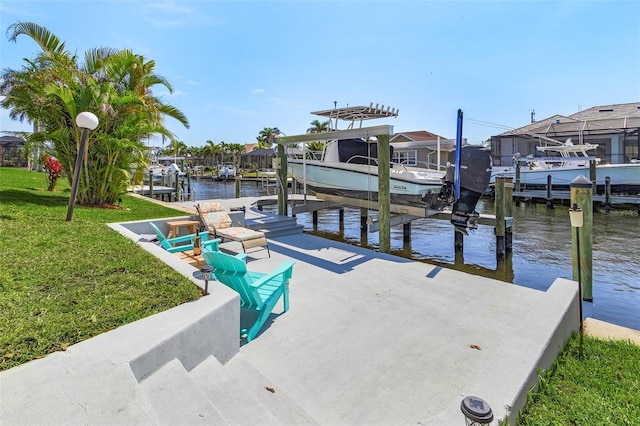 view of dock with a lawn, a water view, boat lift, and a residential view