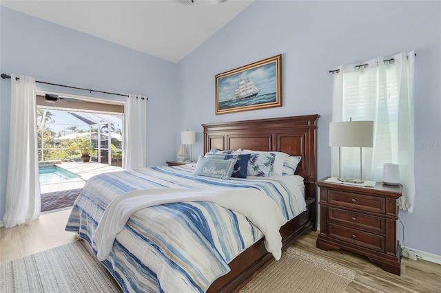 bedroom with vaulted ceiling, access to outside, a sunroom, and light wood-style flooring