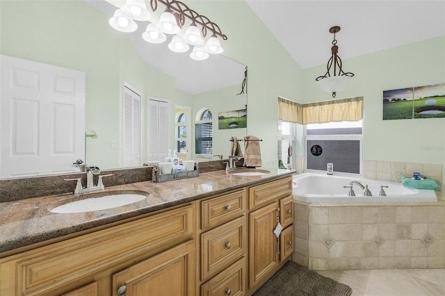 full bath featuring lofted ceiling, a garden tub, a sink, and tile patterned floors