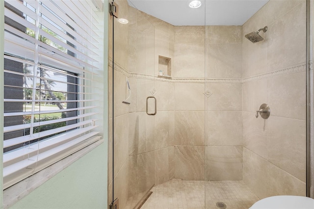 bathroom featuring toilet and a stall shower