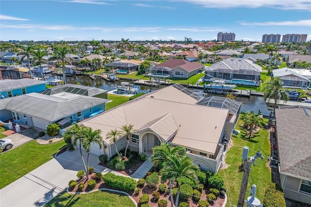 drone / aerial view with a water view and a residential view