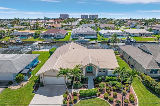 drone / aerial view featuring a water view and a residential view