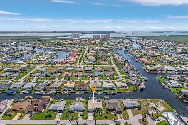 birds eye view of property with a water view and a residential view