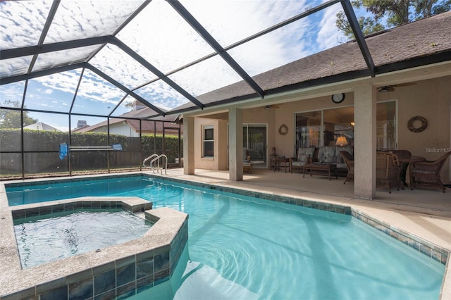 view of swimming pool featuring a patio area, a lanai, an in ground hot tub, ceiling fan, and an outdoor hangout area