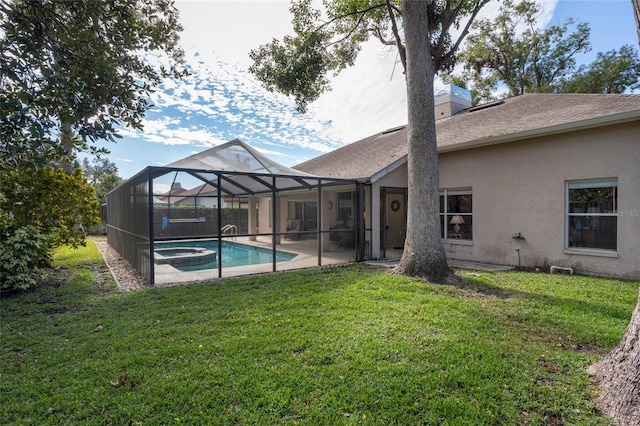 back of house featuring a swimming pool with hot tub, a yard, a patio, and glass enclosure