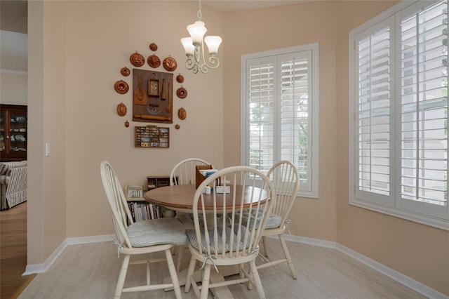 dining room featuring a notable chandelier and light hardwood / wood-style floors