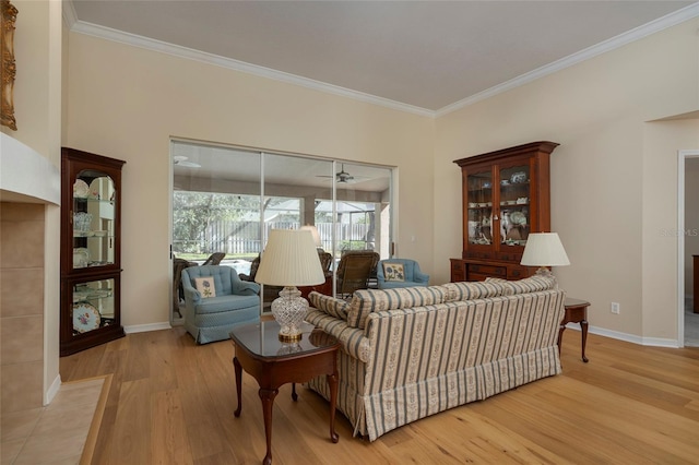 living room with ornamental molding and light hardwood / wood-style flooring