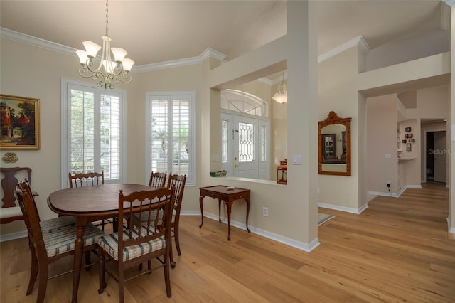 dining room featuring ornamental molding, a chandelier, and light hardwood / wood-style floors