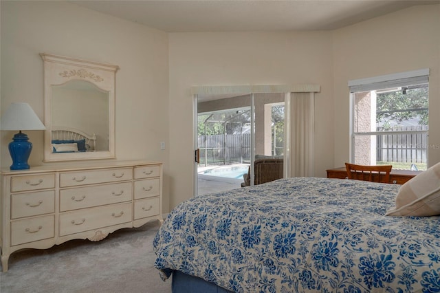 bedroom with carpet floors, multiple windows, and access to outside