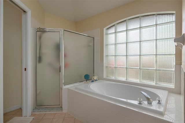 bathroom featuring shower with separate bathtub and tile patterned flooring