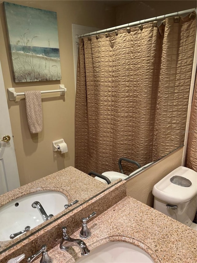 bathroom with vanity, toilet, and a shower with shower curtain