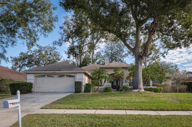 single story home featuring a garage and a front lawn