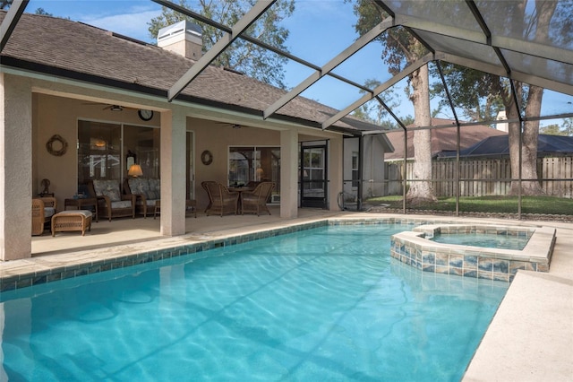 view of swimming pool with a lanai, ceiling fan, outdoor lounge area, a patio area, and an in ground hot tub