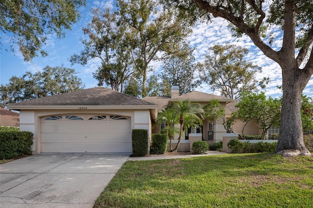 ranch-style house with a garage and a front yard