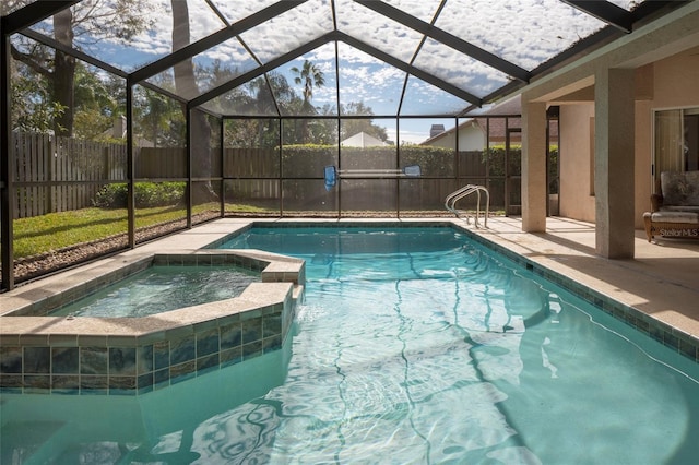 view of swimming pool with a patio area, glass enclosure, and an in ground hot tub