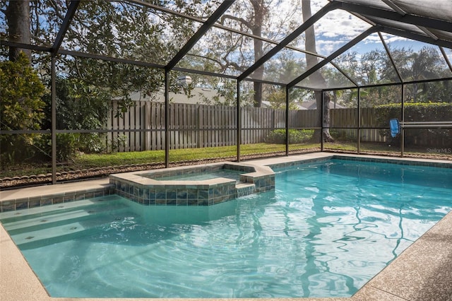 view of pool with an in ground hot tub and a lanai