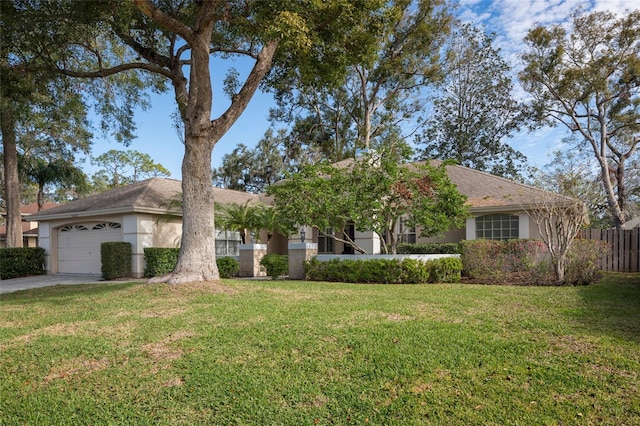 view of front of property with a garage and a front lawn