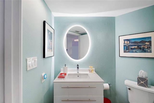 bathroom with toilet and vanity