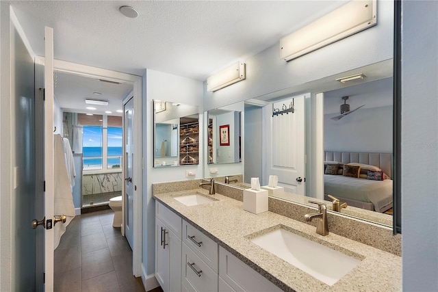 bathroom with vanity, toilet, walk in shower, a wall unit AC, and ceiling fan