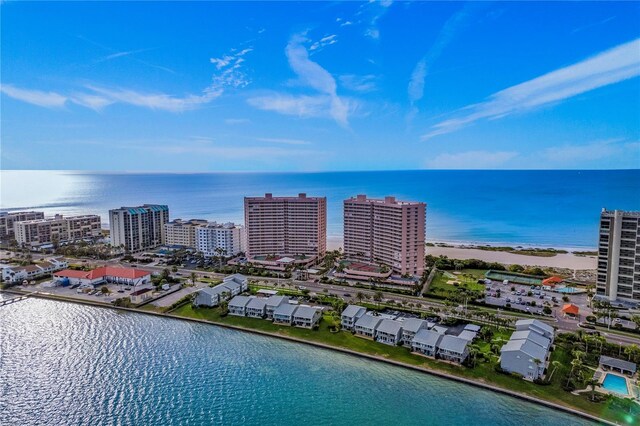 drone / aerial view featuring a water view and a beach view