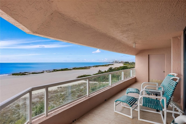 balcony with a beach view and a water view