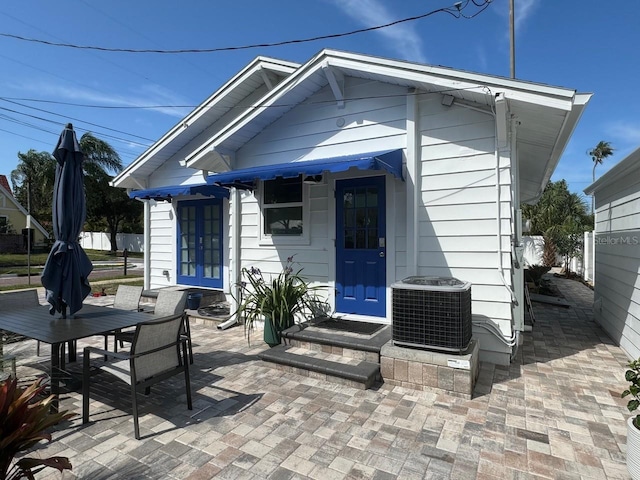 back of property featuring a patio area and central AC