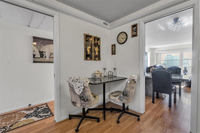 dining space with hardwood / wood-style flooring