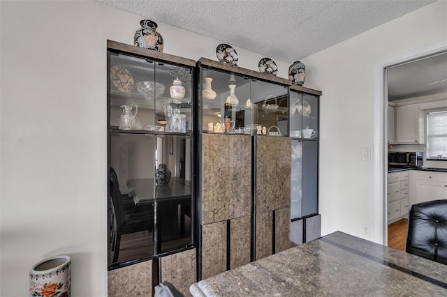 dining space with a textured ceiling and light wood-type flooring