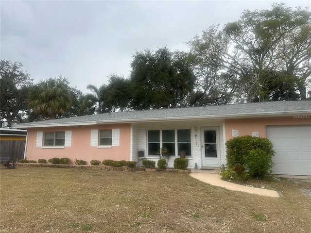 single story home with a garage and a front yard