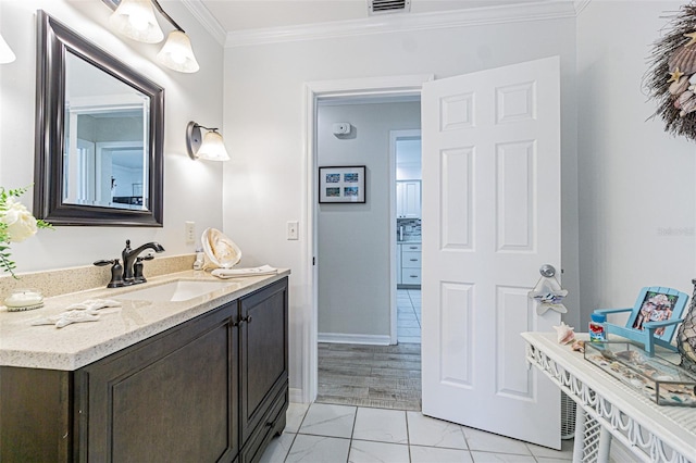 bathroom featuring crown molding and vanity