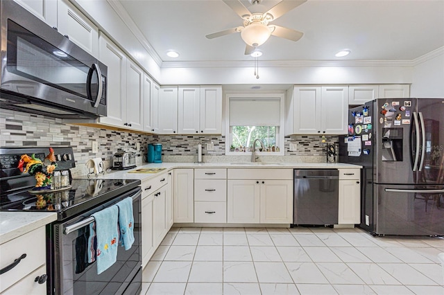 kitchen featuring appliances with stainless steel finishes, sink, and white cabinets