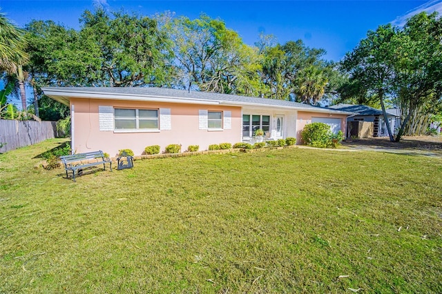 ranch-style home with a garage and a front lawn