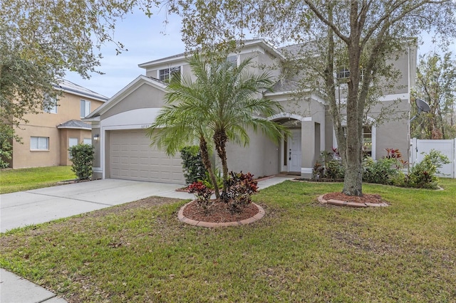 view of front facade featuring a front yard, concrete driveway, an attached garage, and stucco siding