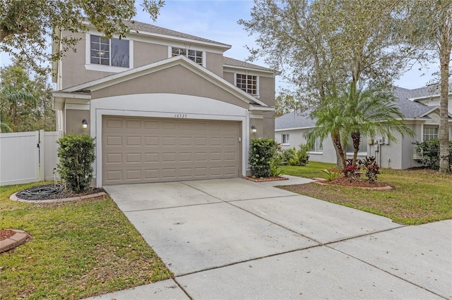 view of front property featuring a garage and a front lawn