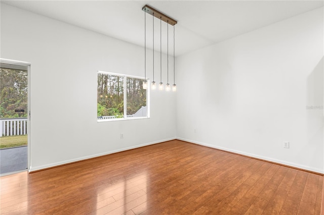 unfurnished room with wood-type flooring