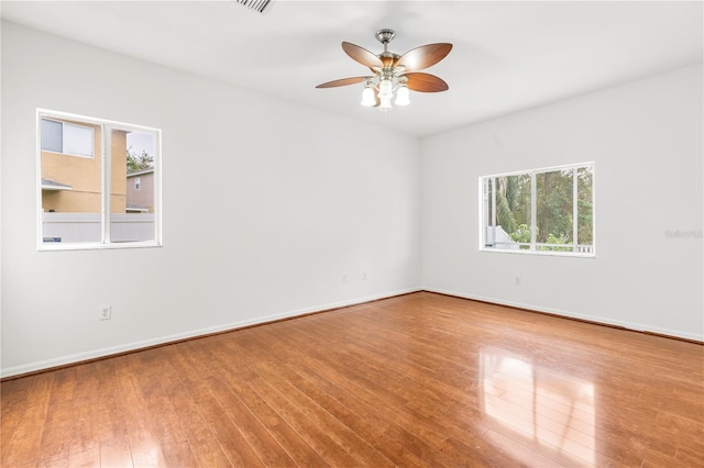 spare room with ceiling fan and wood-type flooring