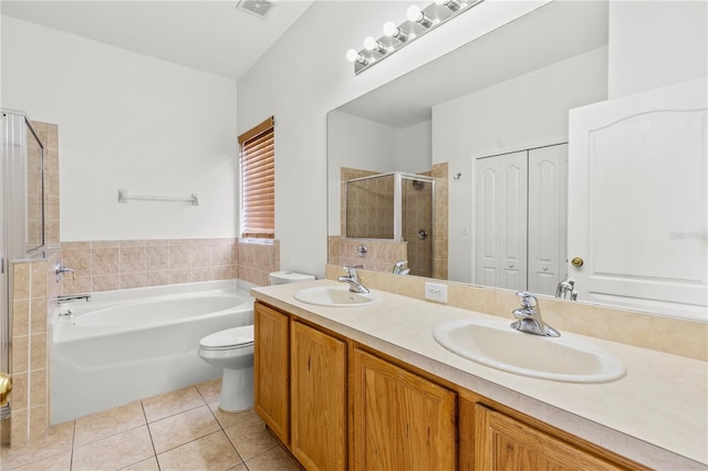 full bathroom featuring toilet, vanity, separate shower and tub, and tile patterned floors