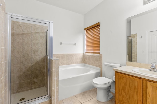 full bathroom featuring toilet, shower with separate bathtub, tile patterned floors, and vanity