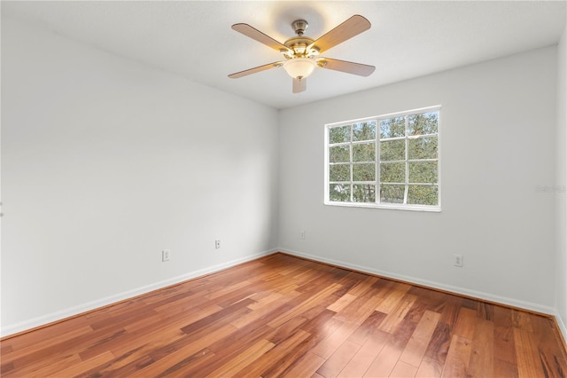 spare room with ceiling fan and hardwood / wood-style flooring