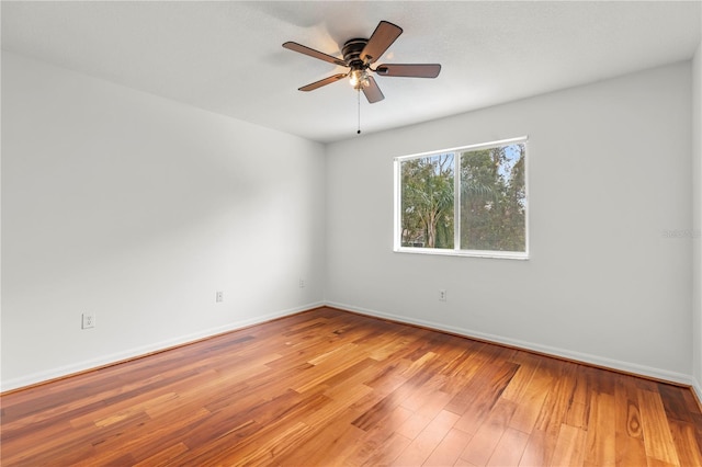 spare room featuring ceiling fan and light hardwood / wood-style flooring