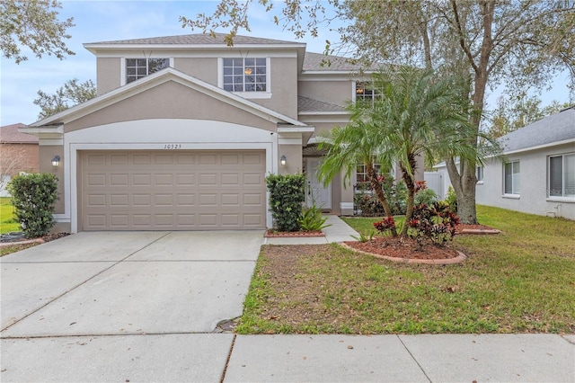 view of front of home featuring a front yard and a garage