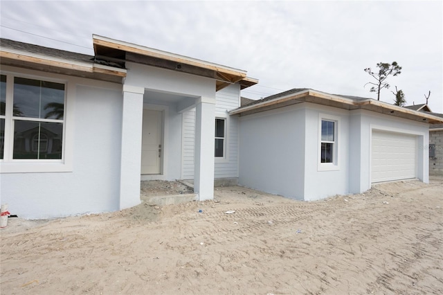 rear view of house with a garage