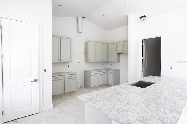 kitchen featuring sink, gray cabinets, and high vaulted ceiling