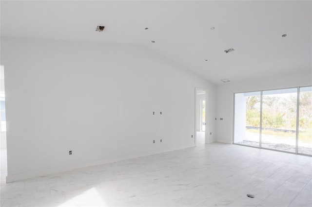 unfurnished room with vaulted ceiling