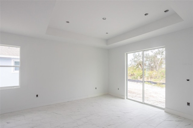 empty room featuring a tray ceiling