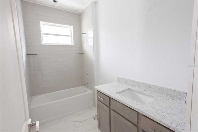 bathroom featuring tiled shower / bath combo and vanity