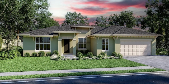 view of front facade featuring a garage and a lawn