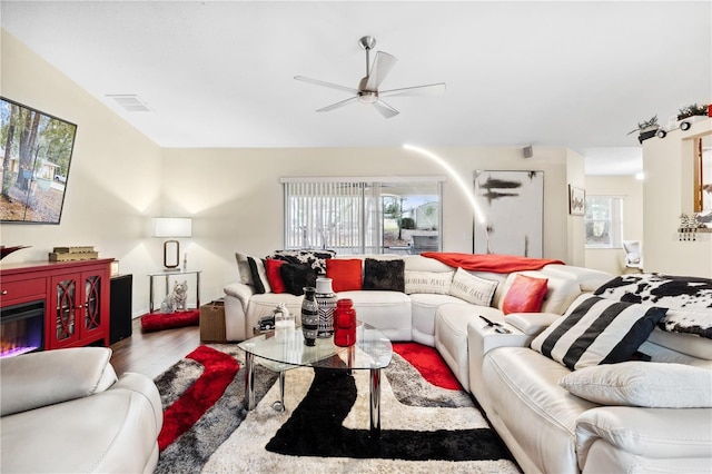 living room featuring hardwood / wood-style flooring and ceiling fan